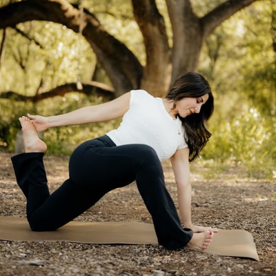 Flow Yoga Cedar Park instructor demonstrating front body opening backbend pose outdoors Austin Texas