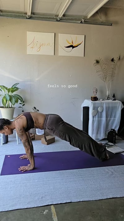 Flow Yoga Georgetown instructor in plank pose on purple mat, Austin Texas