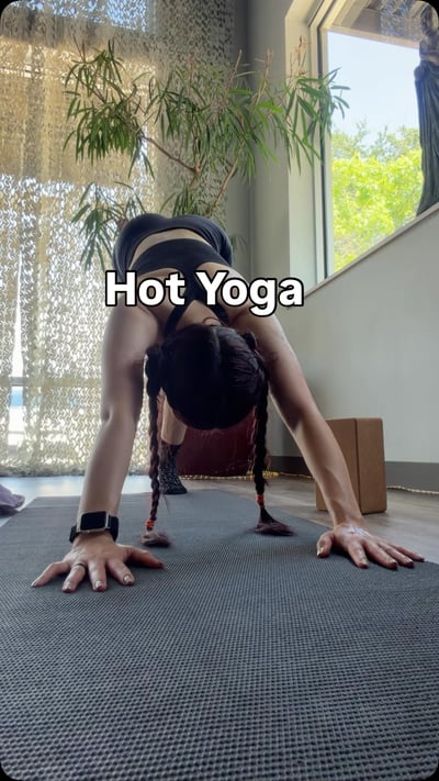 Flow Yoga Cedar Park hot yoga class student in forward bend pose Austin Texas