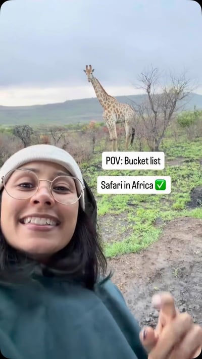 Flow Yoga Cedar Park community member on African safari adventure with giraffe, Austin Texas
