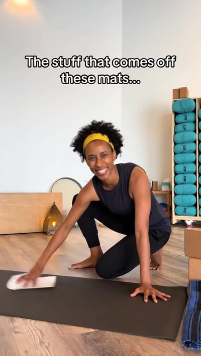 Flow Yoga Cedar Park instructor cleaning yoga mat in studio Austin Texas